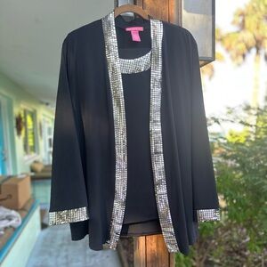 Woman Within Black Jacket, Top and pants with Silver Accents.